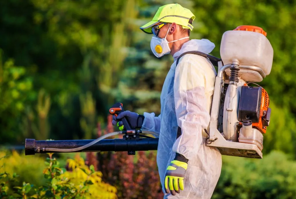 Professional Pest Control technician doing mosquito control treatment