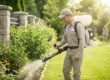Mosquito Control Treatment performed by a uniformed pest control worker spraying a residential property.
